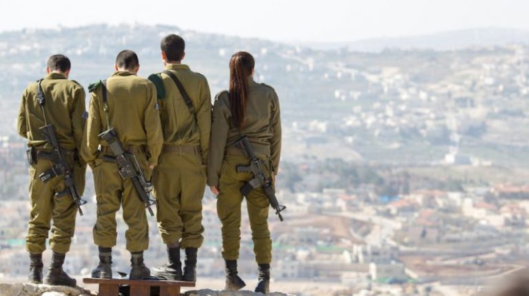 Safe Overclocking - three men and one woman soldiers standing on rock during daytime