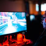 Game Development - person using computer playing FPS game