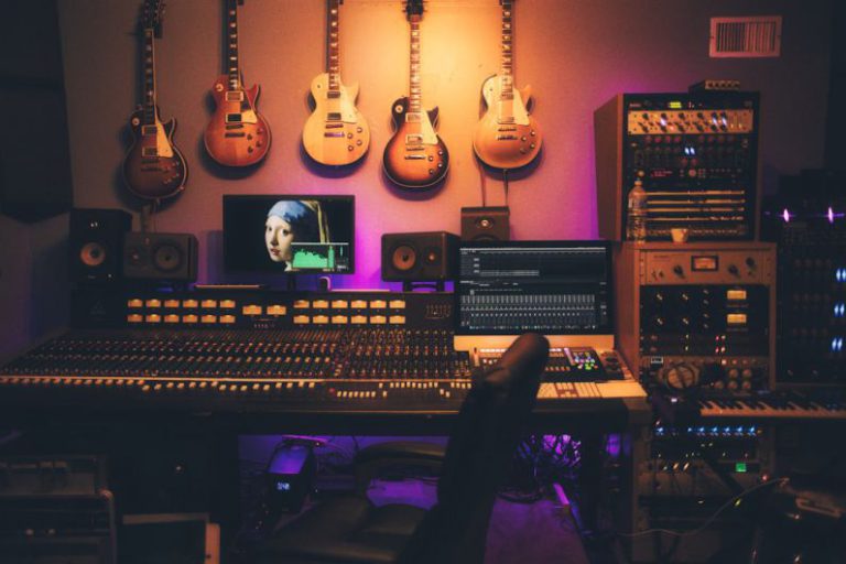 Music Production - person playing brown and white acoustic guitars