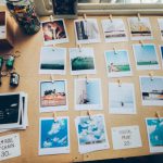 Photography Workstation - assorted photos on beige wooden table