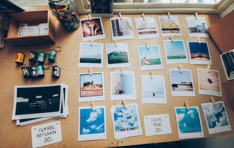 Photography Workstation - assorted photos on beige wooden table