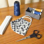 Router DIY - black handled scissors beside blue thread and white and black checkered pouch