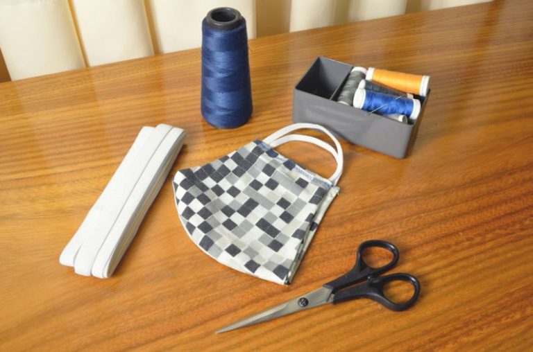 Router DIY - black handled scissors beside blue thread and white and black checkered pouch
