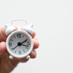 PC Build Time - person holding white mini bell alarmclock