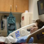 Cooling Case Choice - boy lying on beige recliner hospital bed