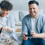 Antivirus Gaming - Two people sitting on a bed playing video games
