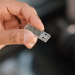 Software Tools - Man using flash drive storing files and information