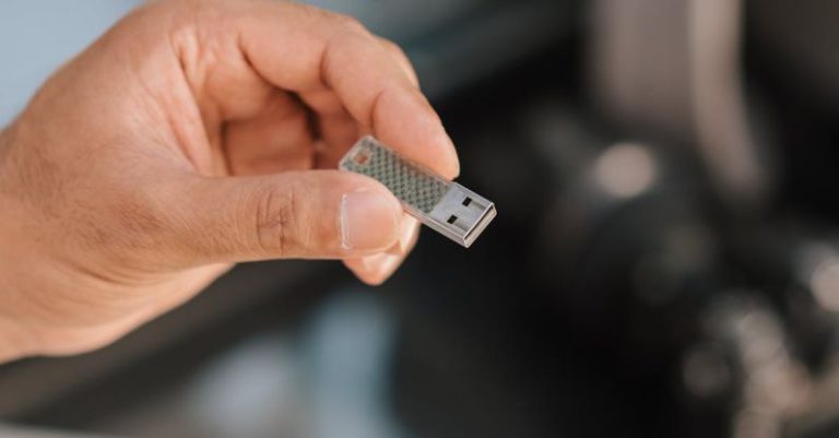 Software Tools - Man using flash drive storing files and information