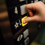 Operating System Choice - Anonymous person pressing button of lift