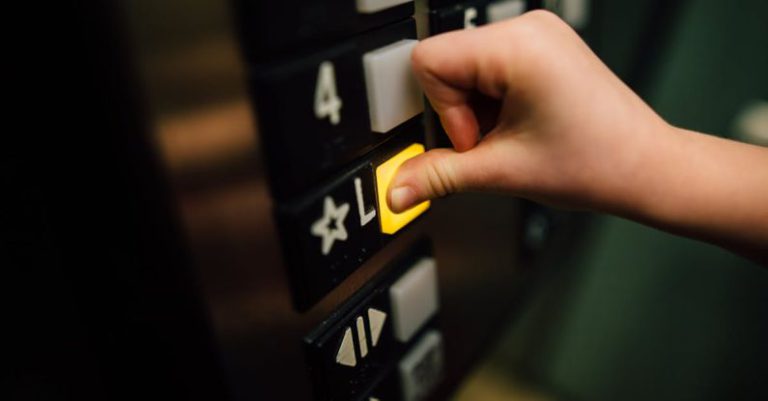 Operating System Choice - Anonymous person pressing button of lift