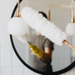 Cleaner Tools - Crop woman dusting lamp during housework