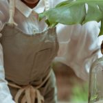 Home Server - Focused housewife in apron cleaning wooden table