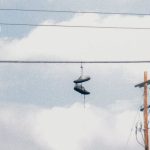 Aesthetic Build - Pair of Shoes Hanging on Electric Wire