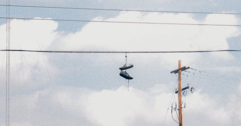 Aesthetic Build - Pair of Shoes Hanging on Electric Wire