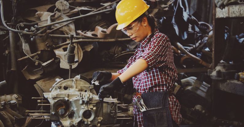 Overheating Fix - Woman Wears Yellow Hard Hat Holding Vehicle Part