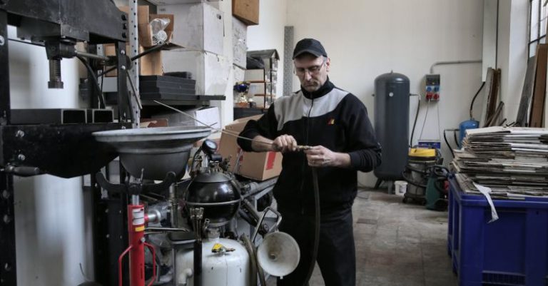 BIOS Troubleshooting - Focused mechanic repairing compressor hose in workshop