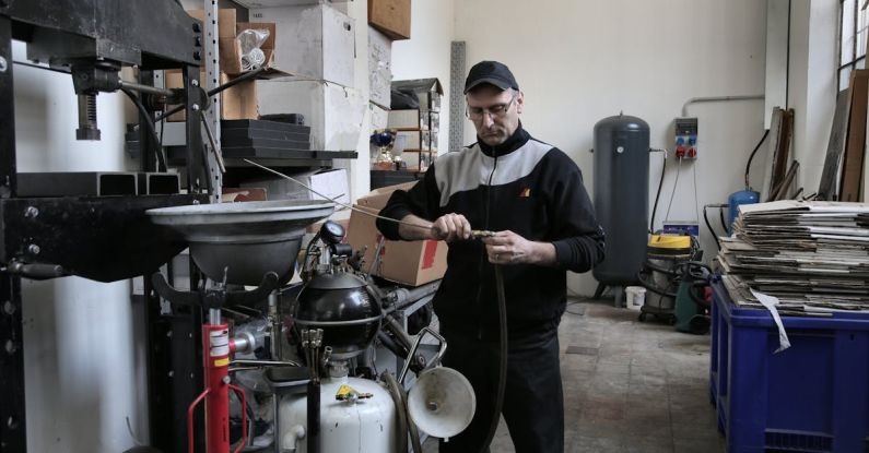 BIOS Troubleshooting - Focused mechanic repairing compressor hose in workshop