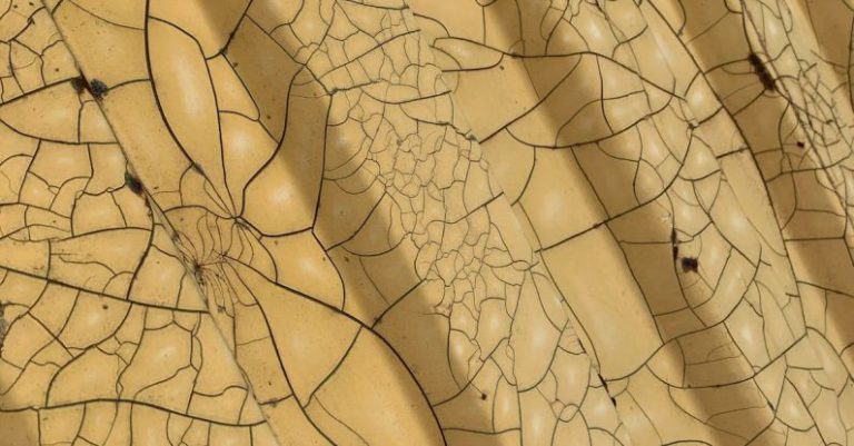 Acrylic Panel - From above of geometric yellow surface with symmetric patterns and cracks as abstract background
