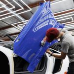 Vinyl Wrap - A Man Putting on a Blue Sticker on the Car Door