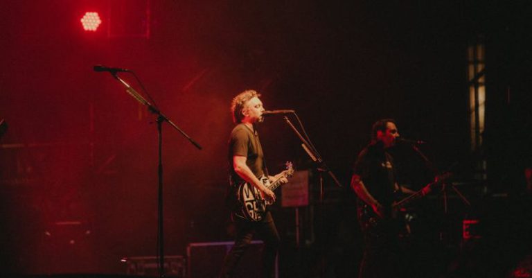 Performance Budget - A band playing on stage with red lights