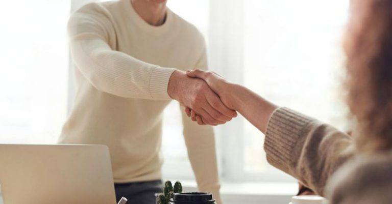 Negotiating Deals - Man and Woman Near Table