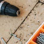 Workstation Build - From above of assorted carpentry tools in plastic case placed with metal hammer and screwdriver