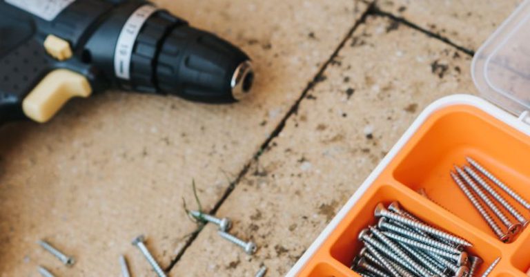 Workstation Build - From above of assorted carpentry tools in plastic case placed with metal hammer and screwdriver