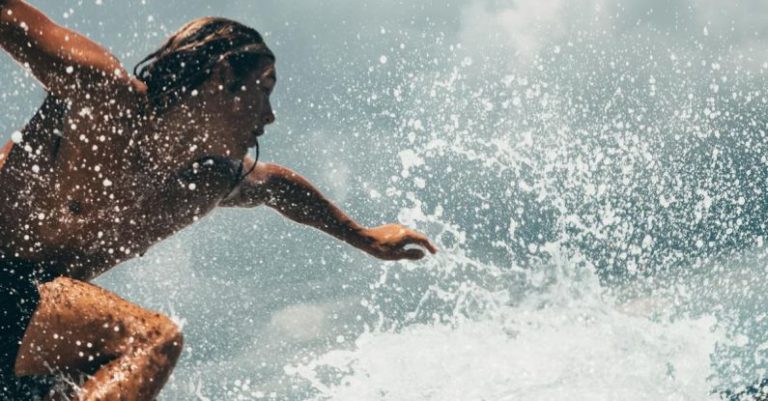 Overclocking Extreme - Man Riding White Surfboard