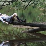Water-cooled Dream - Woman Lying on Tree Near Awter