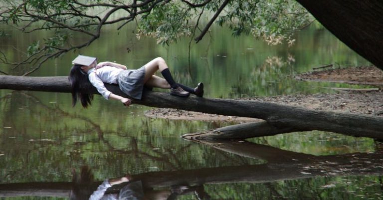 Water-cooled Dream - Woman Lying on Tree Near Awter