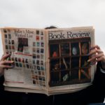 BIOS Update - Person Holding White and Brown Newspaper