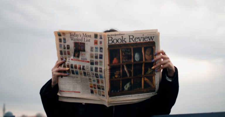BIOS Update - Person Holding White and Brown Newspaper