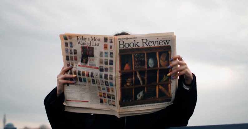 BIOS Update - Person Holding White and Brown Newspaper